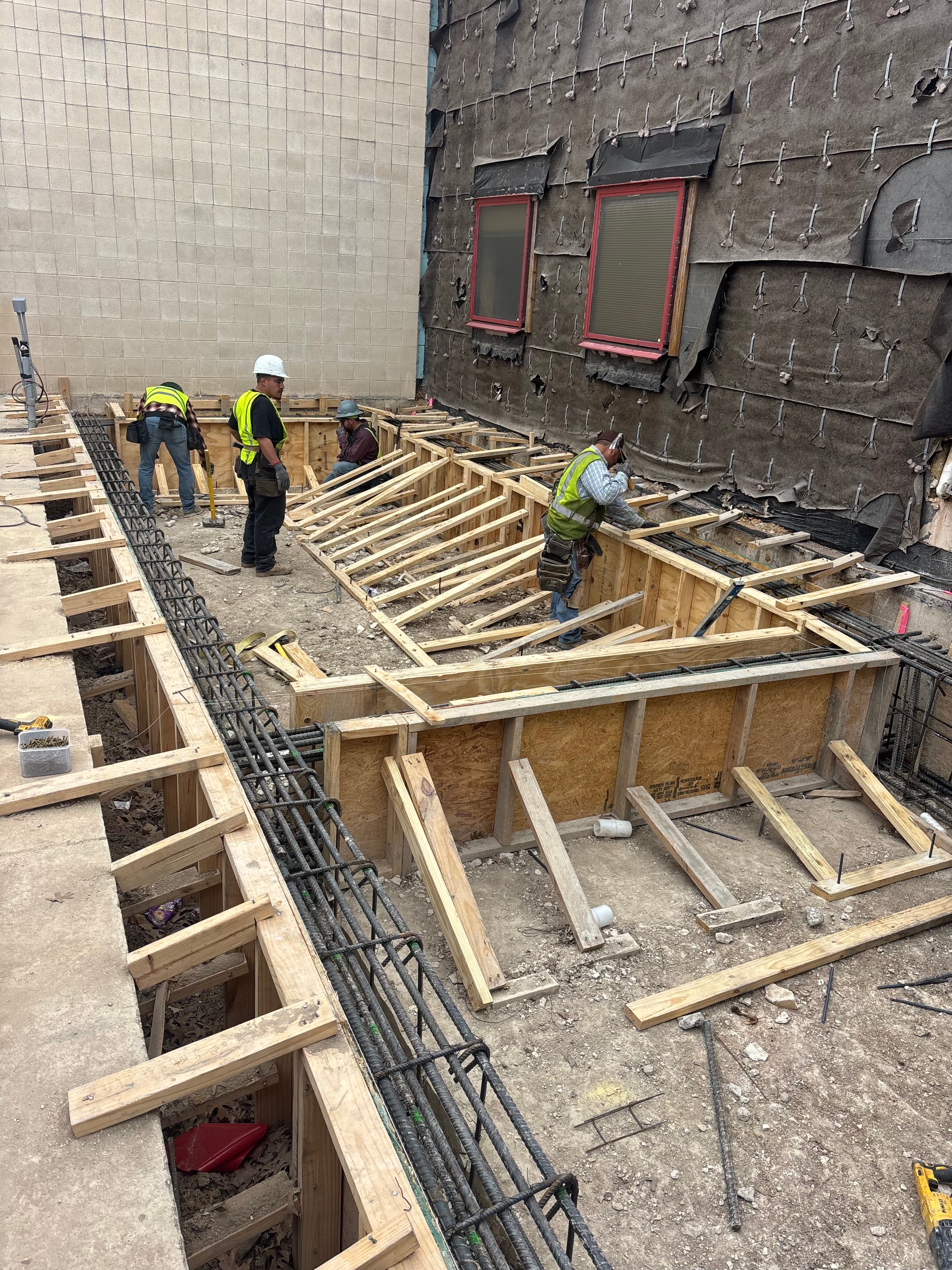 Commercial concrete elevated beam forming with crew and rebar in North Texas