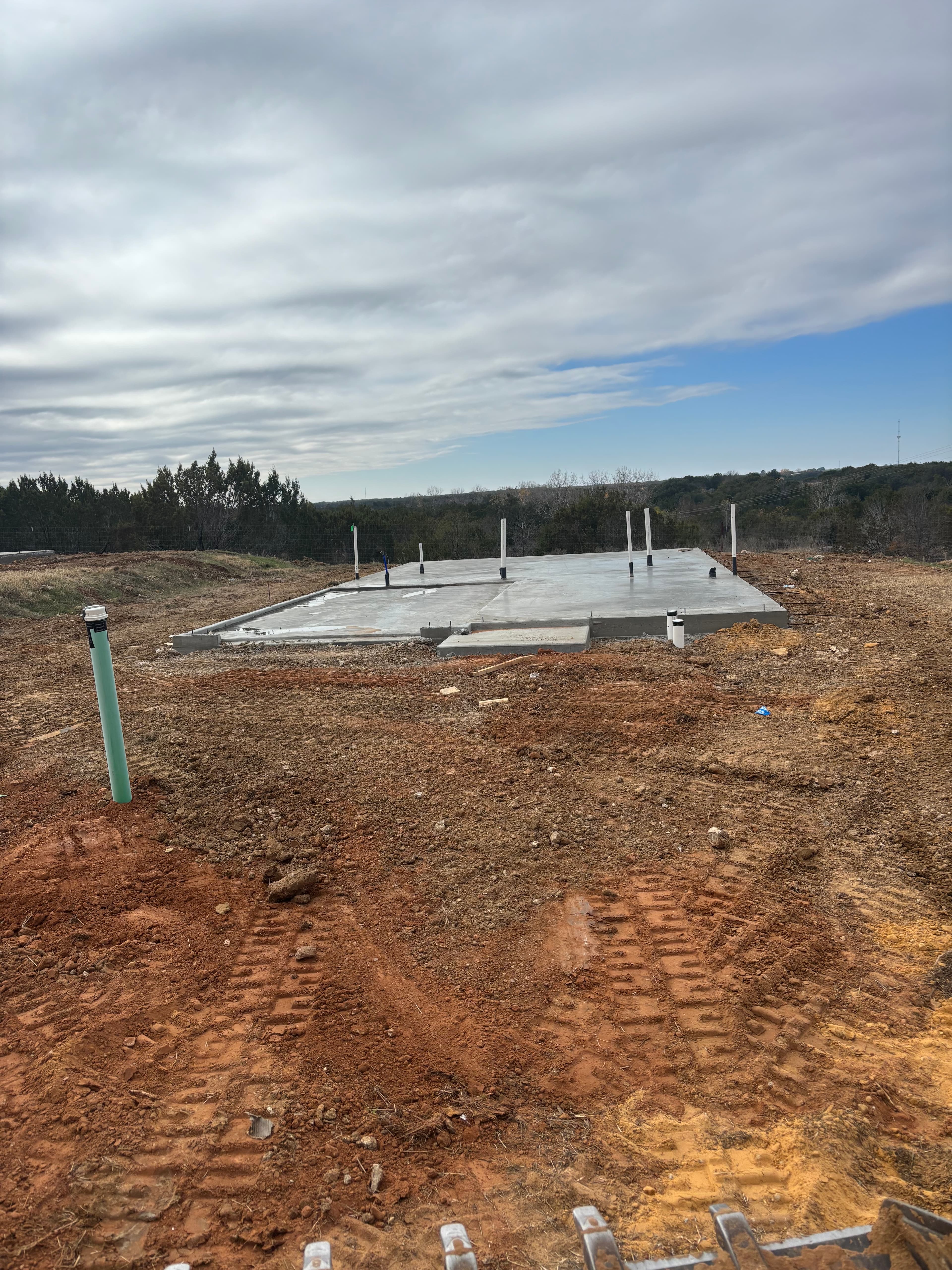 Graded and formed concrete slab with anchor bolts in North Texas