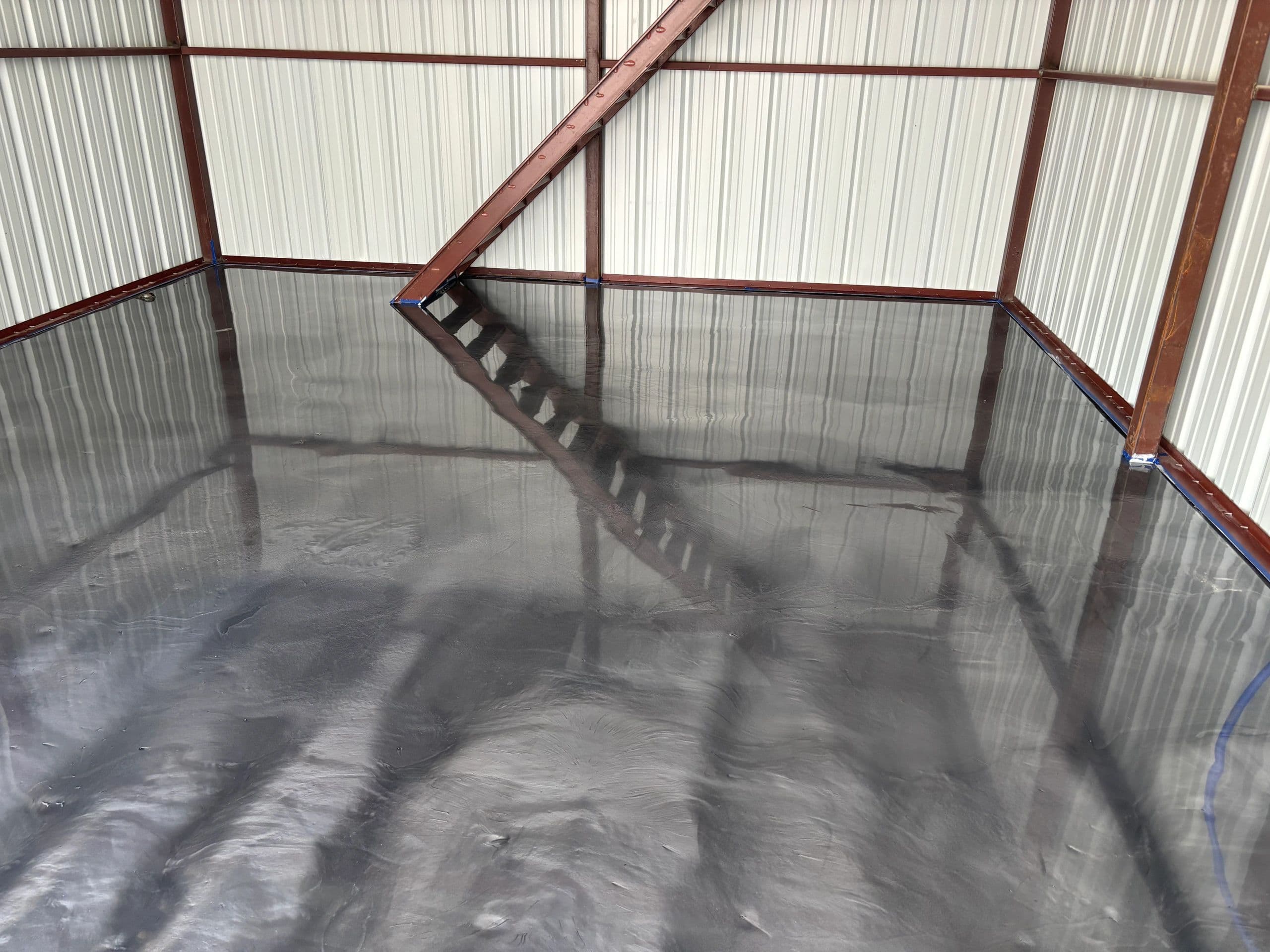 Metallic epoxy finish on shop building concrete floor