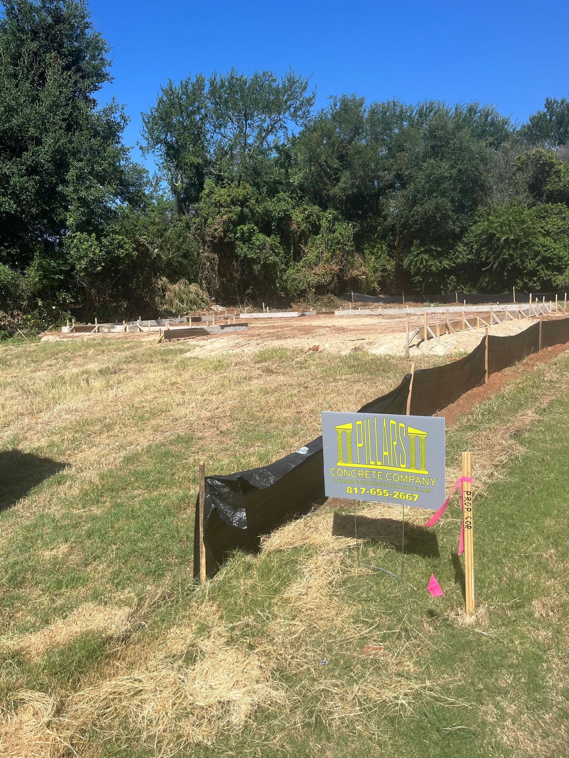 Pillars Concrete LLC foundation job site with company sign, North Texas