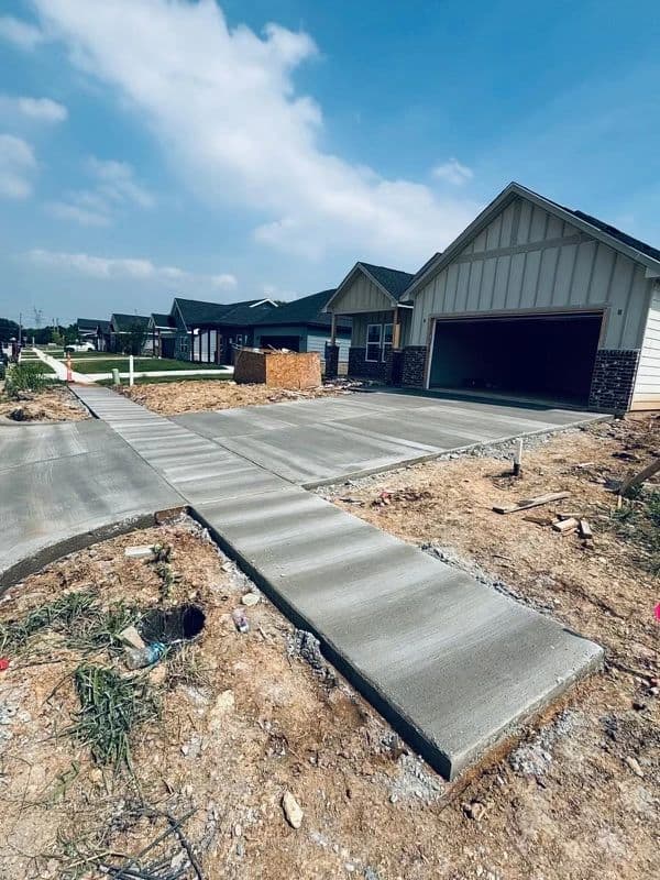 New concrete driveway and sidewalk approach on residential street
