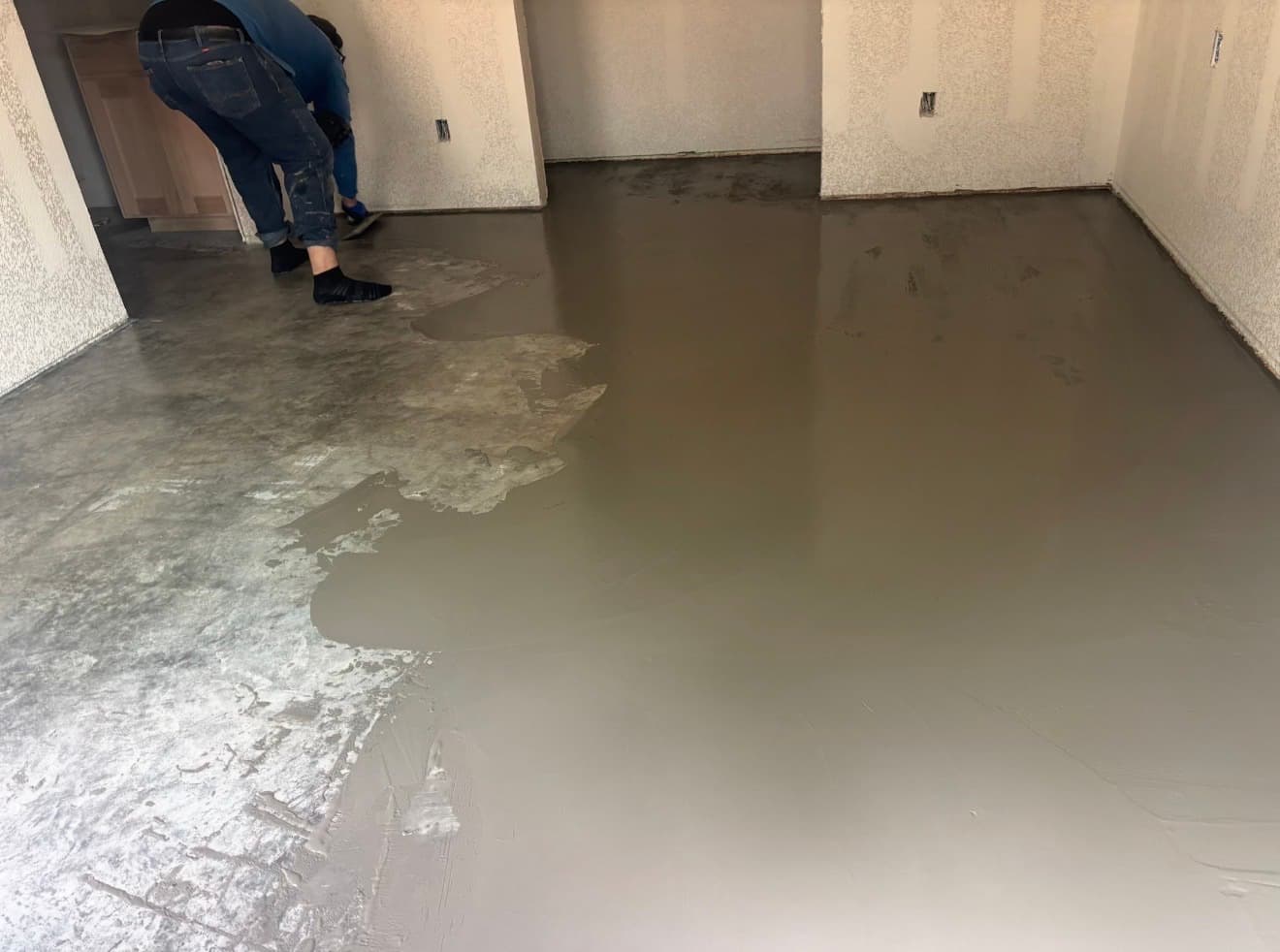 Concrete resurfacing overlay being applied to interior floor